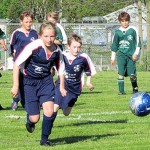 County players charge onto the soccer field