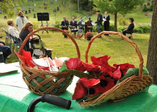 Canadian flags and poppies placed on graves during the first Veteran's Day service at Glenwood Cemetery, Picton. Peggy deWitt photo