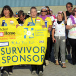 Sarah Reddick and Nancy Etmanski held the Survivor's Walk banner as more than 150 cancer survivors made their way around the "Victory Lap" at the fairgrounds.