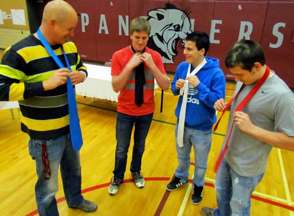 PECI Guidance Department's Matt Ronan held some necktie tying instruction and contests at PECI Friday in conjunction with the second annual Prom Project event at the school. Joining the friendly competition here were students Ben Wilson, Josh VanVlack and Brandon Markolefas.