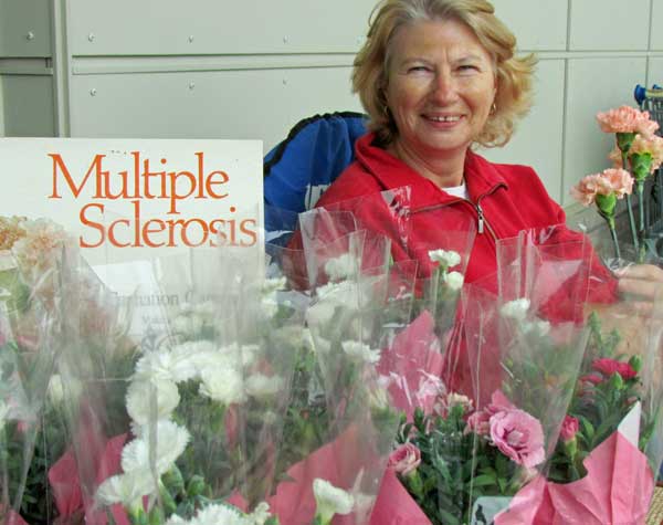 Volunteer Susan Eastbury among the many volunteers who braved the cold and wind to sell carnations for the PEC MS chapter.