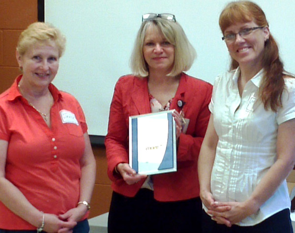 Katherine Stansfield, QHC vice-president of patient care services (centre) presents an award for high completion rates in a 'Managing Obstetric Risk Effectively' three-year program, to Janice Heard, Picton obstetrical nurse, (at left) and Margaret Tromp, Picton family physician who does maternity care.