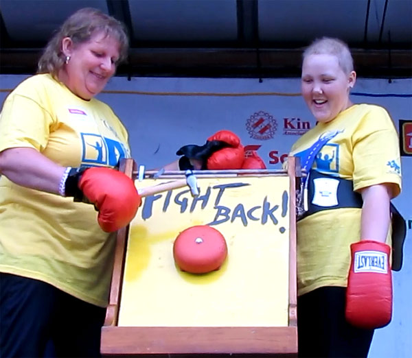Inch, along with Sarah Reddick, a PECI student who is battling cancer for a second round, donned their "Fight Back" gloves and rang the bell to signify the official start of the evening's walking and then led the 'Survivor Lap'.