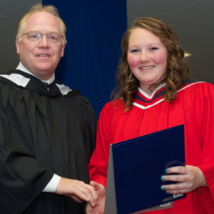 Gary Dyke, Loyalist College Board of Governors, presented Emily Reddick of Picton with a Social Service Worker diploma and the Bayfield Treatment Centres Award for academic performance.