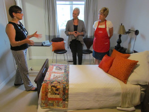 Heather Campbell, Hospice Prince Edward residential project manager, demonstrates the new bed's capabilities to Prince Edward County Memorial Hospital Auxiliary's Dorothy Speirs-Vincent, director of communications, and Peggy Payne, president.
