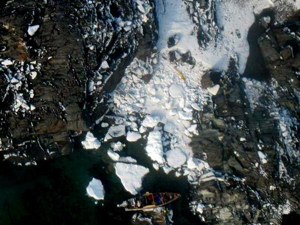 The stricken freight canoe is at bottom frame, which suffered an electrical fault leading to four hunters being stranded on an island in the area of Fury and Hecla Straight near Igloolik, Nunavut on Sunday, August 24, 2013.