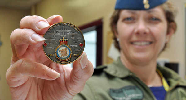 Capt. Gillian Parker displays the newly minted 424 Sqn. anniversary coin featuring the aircraft the squadron has flown on one side and their battle honours on the other. To make contact to purchase the coin, E-mail squadron424@yahoo.ca or telephone 613-885-4823. Ross Lees photo