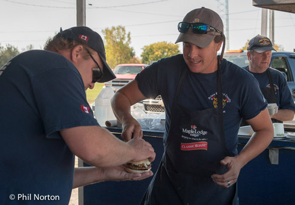 Ameliasburgh Fire Department serving quarter-pound hamburgers with fried onions--Brad Belch cooking.