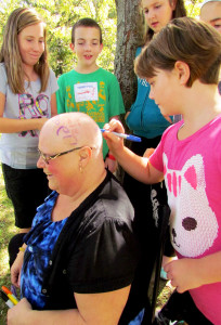 Gail MacDougall has her head signed during the school's Terry Fox Run activities.