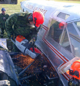 WO Jason Houle works on cutting off the wing of the C-45 Expeditor in Portage la Prairie.