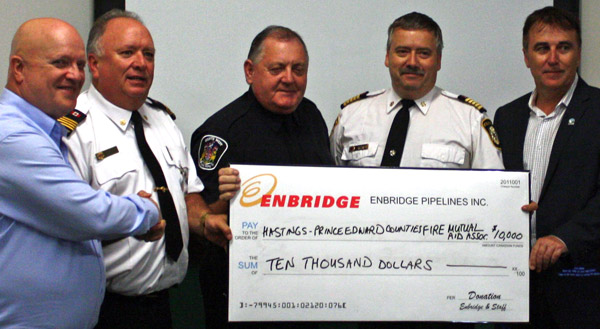 Enbridge Pipelines Inc. presented a $10,000 Safe Community donation toward the expansion of the Hastings-Prince Edward Counties Fire Mutual Aid Association training tower. Enbridge representative J.D. Booth (far left) is pictured making the donation to association officials, including, from left: Deputy Fire Chief Robert Rutter of Prince Edward County; Chuck Naphan of the Quinte West Fire Department (and president of the Mutual Aid Association); Fire Chief Richard Caddick of the Township of Stirling-Rawdon; and Belleville Mayor Neil Ellis.