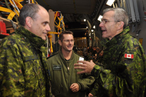 Checking the facts - Col. Lowthian and 8 Wing Operations Officer Lt.-Col Christian Roy listen as Maj. Gen. Ferron as he discusses the final details of the trip with them just prior to takeoff Wednesday night. Photo Ross Lees 