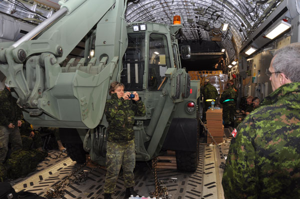 Documenting the exercise - Maj. Gen. Jim Ferron, Commanding Officer of the 1st Canadian Division based in Kingston, observes as a responding DART team member photographs some other members while standing in front of a huge front-end loader which Maj. Gen. Ferron thinks will make a big difference in the Phillipines. Photo Ross Lees