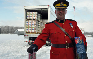 RCMP Inspector Todd Gilmore watches the process of transporting toys to northern children begin. Photo Ross Lees