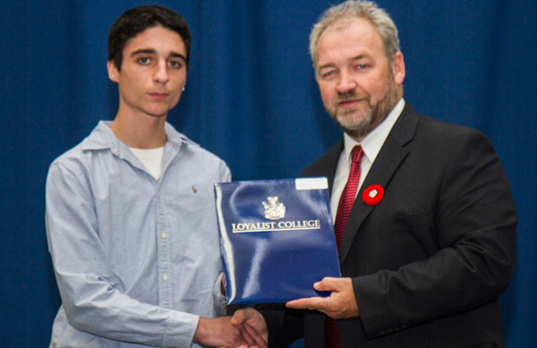 Mason Gignac (left), first-year Electrical Technician – Industrial student, was presented a Loyalist College Dual Credit Bursary by Loyalist College Vice-President Academic, John McMahon. Mason is a PECI graduate.  