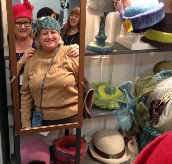 Chris Hall, of CakeTin Hats helps Karen Empringham decide on a favourite hat.