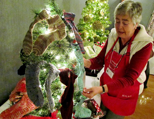 In between directing exhibitors, the Auxiliary's Sue Law arranges socks and slippers on one of the Auxiliary's entries.