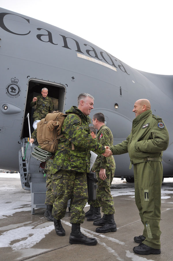 Canadian DART team members are welcomed back to CFB Trenton by Lt.-Gen. Yvan Blondin, Commander of the Royal Canadian Air Force and other high ranking military and civilian officials Dec. 19. - Photo by Ross Lees