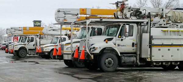 Nine Hydro One trucks from Ottawa during the lunch hour Monday, Dec 2 at the Prince Edward Square Plaza in Rossmore.  John Ferguson photo