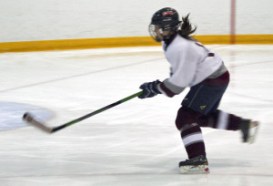 Sam Ward chases a loose puck.