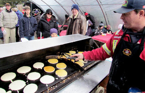 Hallowell fire department's Al Koopmans creating perfect pancakes on the grill