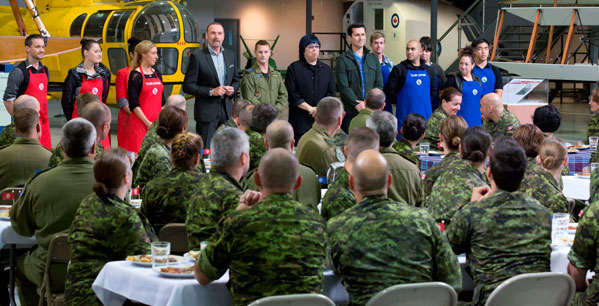 MasterChef judge, Michael Bonacini, presents to 8 Wing members the top 10 participating home cooks. CTV photo