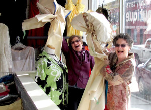 Debbie Manlow and Debbie MacDonald Moynes celebrate the opening of the shop by peeling the brown paper off the windows.