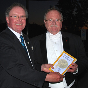 Prince Edward Lodge past master Dale Miller presents Historian Alan R. Capon's book to Donald Campbell, Grand Master.