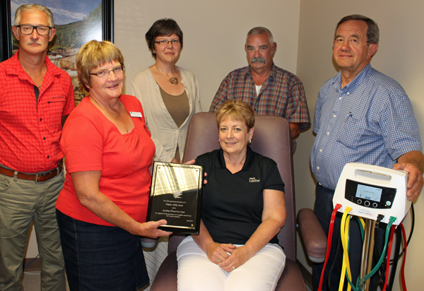 Dr. John French, Sylvia Kempers and Stephanie MacLaren and Dr. John Hancock, of the Prince Edward Family Health Team, present an appreciation plaque to the PEC Cattlemen's Association's Marilyn and Craig Carson in thanks for their support.