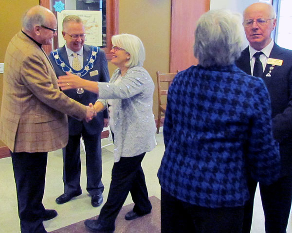 Keith MacDonald is greeted by Mayor Robert Quaiff and his wife Susan, while MacDonald's wife, Eleanor Lindsay, speaks with councillor Gord Fox.