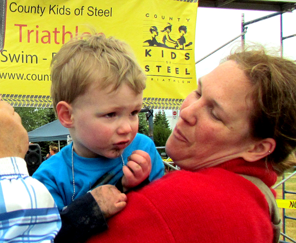 Rhys Kelly, of Cherry Valley, who will be three in June, gets a hug at the finish line from mom, Alison.