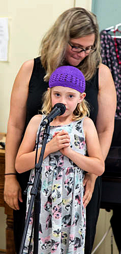 Six-year-old Nora Williamson sings her solo with a little backing from her mom. 