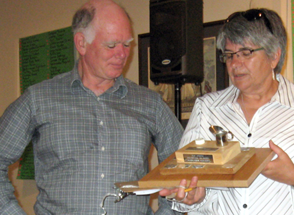 David Okines receives the Laphroaig Trophy from Kathy Felkar.