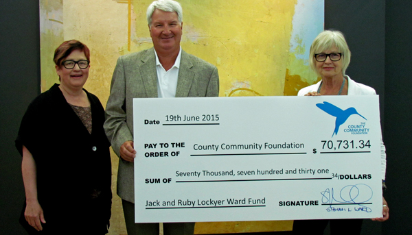 Carlyn Moulton, owner of the OENO Gallery, looked on as Steven Ward presented the funds to establish the Jack and Ruby Lockyer Ward Fund to Joan Pennefather, president of the County Community Foundation. The donor advised fund will be administered by the County Community Foundation. 