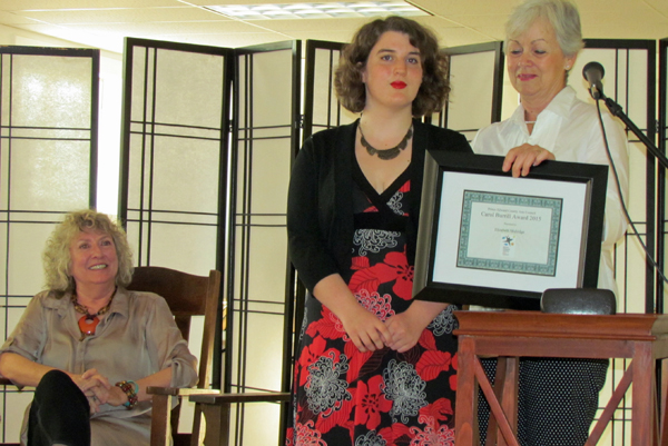 Arts Council chair Susanne Barclay watches as director Mary Tucker presents the Carol Burrill Award to Elizabeth Mulridge.