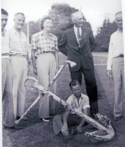 Keith MacDonald, sits by the anchor, in the photograph taken when it was hoisted out of the water.