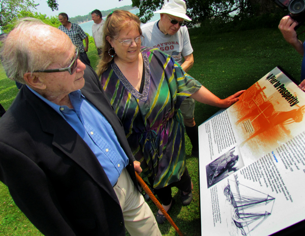 Keith MacDonald, Diane Denyes-Wenn and Doug McQueen look at one of the three new plaques.