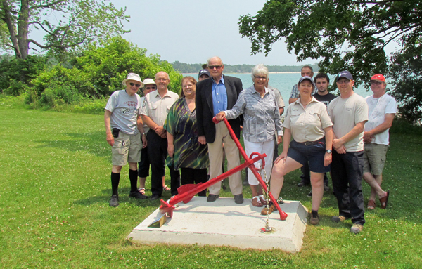 Keith and Eleanor MacDonald, centre, with guests attending the unveiling the the anchor schooner and an interpretive display of the property's history.