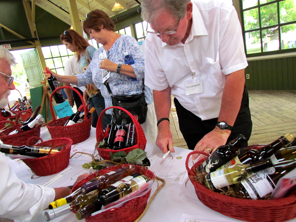 Guests support the silent auction of baskets of wine.