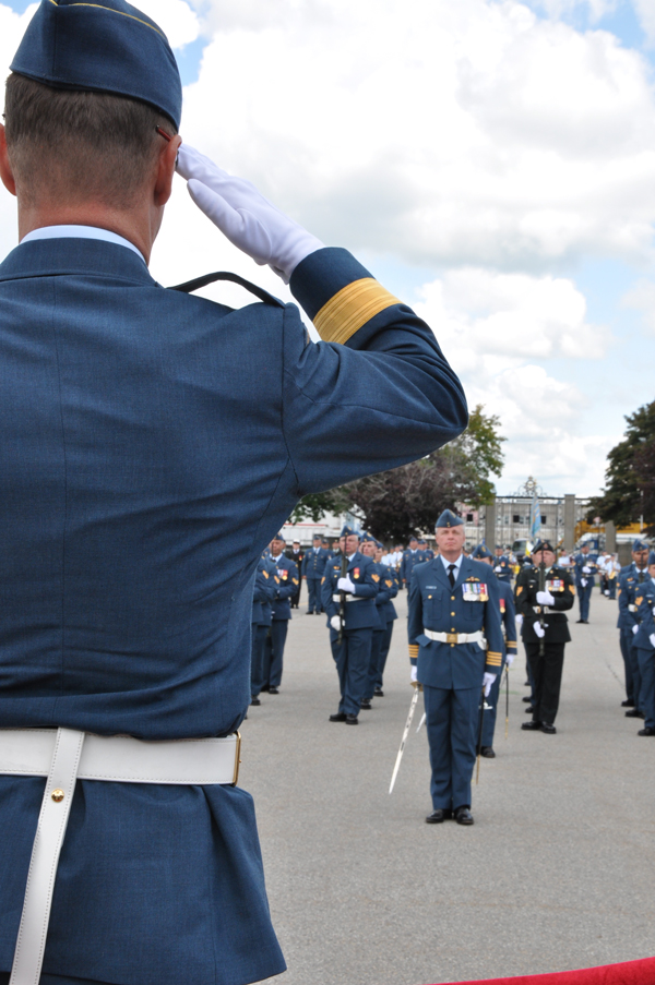 Brig.-Gen. David Lowthian, foreground, takes the salute from new 8 Wing Commander, Col. Colin Keiver and an Honour Guard in front of the ceremonial gates on the parade square at CFB Trenton. Ross Lees photo 