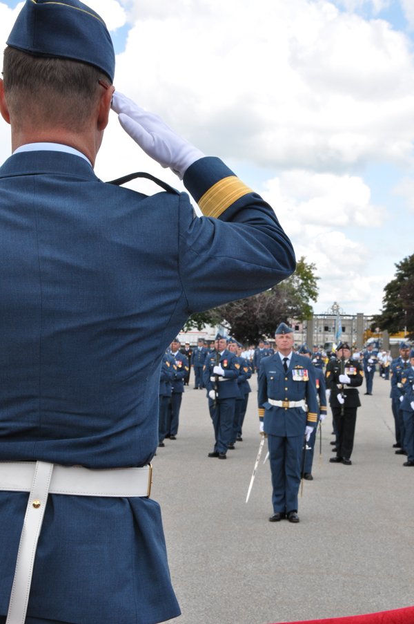 Brig.-Gen. David Lowthian, foreground, takes the salute from new 8 Wing Commander, Col. Colin Keiver and an Honour Guard in front of the ceremonial gates on the parade square at CFB Trenton. Ross Lees photo