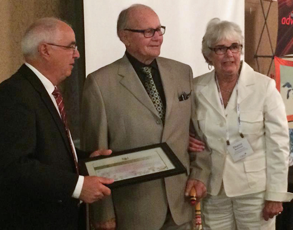 Eleanor MacDonald accompanies her husband, former County councillor and MPP Keith MacDonald, to receive an award honouring his municipal service from Northumberland MPP Lou Rinaldi at the Eastern Municipal Conference in Kingston last week. -Robert Quaiff photo