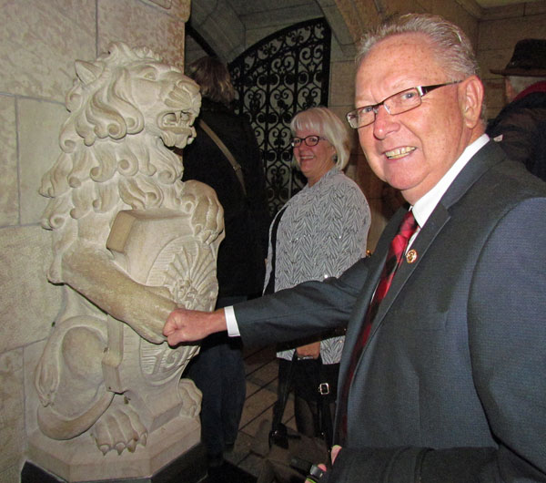 Mayor Robert Quaiff, with Susan, 'fist-bumps' the lion outside the elevator to the Peace Tower - a tradition Prime Minister Justin Trudeau shared with his children earlier this month, that was started by the man who replaces the flag each day.