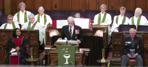 John Inrig flanked by officiants Rev. Aruna Alexander and Padre Bill Kidnew. Behind, the Picton United Choir members who presented David Colwell's choral presentation of In Flanders Fields'