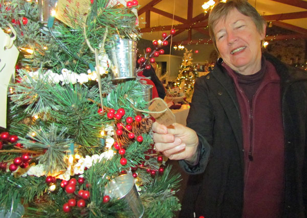 Sandy Smith checks a few  "bucket list" ideas. Hospice Prince Edward presented a "Bucket List" tree encouraging people to live a fuller life by removing the taboo of death and dying.