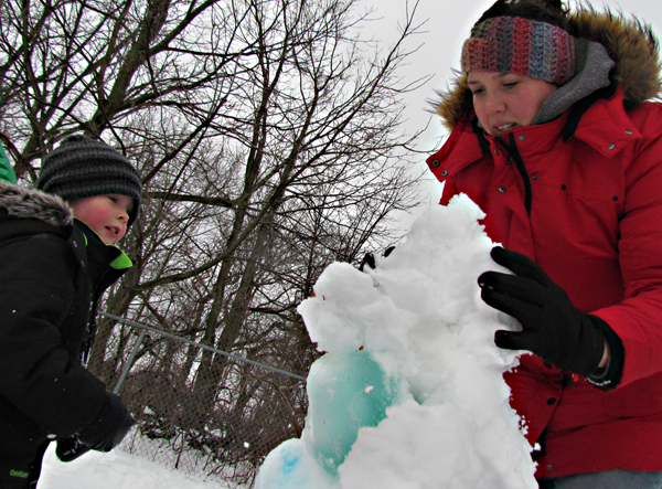 Elliott helped mom, Beth, to build a snow and ice creation.
