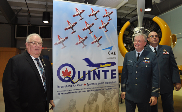 Quinte West Mayor Jim Harrison, 8 Wing Commander Col. Colin Keiver and WCWO Darcy Elder unveil the Quinte International Air Show poster during the official announcement of the QIAS Thursday morning.- Ross Lees photo