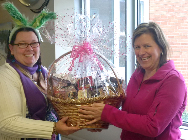 Hopping in to present a delightful basket of donated goodies to nurse Carolyn Miller, right, is Briar Boyce, communications co-ordinator with the PECMH Foundation. - Lisa Mowbray photo