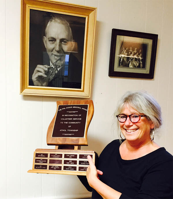 Cherry Valley resident Janet Davies, 2016 winner of the memorial Phil Dodds Award in recognition of volunteer service to the community of the Athol, pictured under the photo of Phil Dodds in the town hall in Cherry Valley.