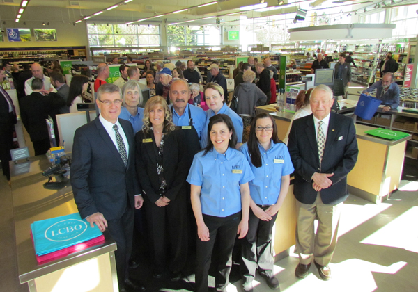 LCBO acting president and CEO George Soleas, store manager Bobbie-Jo McCamon and Hospital Foundation chair Leo Finnegan pose for a photograph on opening day with some of the Picton staff.
